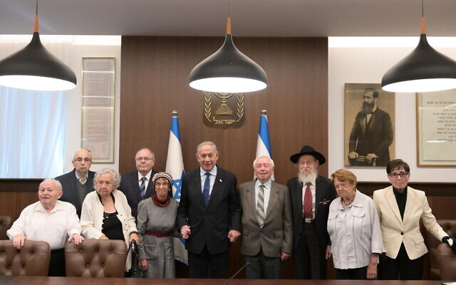 Prime Minister Benjamin Netanyahu (center) meets with the torchlighters for this year's Holocaust Remembrance Day ceremony, at his office in Jerusalem, April 16, 2023. (Amos Ben Gershom/GPO)