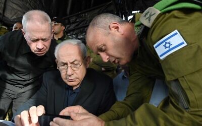 Defense Minister Yoav Gallant (left) and Prime Minister Benjamin Netanyahu, with OC Central Command Yehuda Fox, at the scene of a terror attack in the Jordan Valley on April 7, 2023. (Haim Zach/GPO)