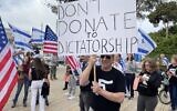 Protesters against the government's judicial overhaul greet participants of the Jewish Federations of North America’s General Assembly in Tel Aviv, April 23, 2023. (Carrie Keller-Lynn/Times of Israel)