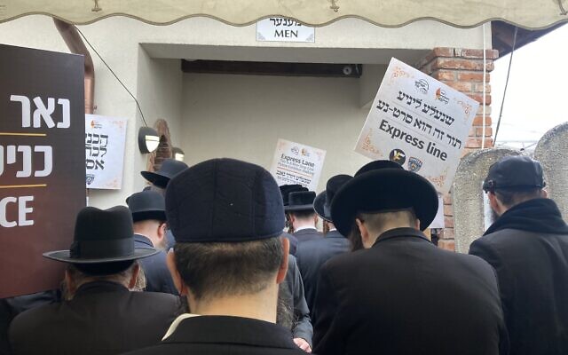 Orthodox Jews pray at the gravesite of 'Wonder Rabbi' Yeshaya Steiner in Bodrogkeresztur, Hungary, April 24, 2023. (Yaakov Schwartz/ Times of Israel)