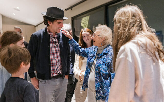 Gal Gadot hosted Holocaust survivor Celina Biniaz, being greeted by Sacha Baron Cohen, for a Zikaron Basalon event on Holocaust Remembrance Day, April 18, 2023 (Courtesy Tori, DMWA)