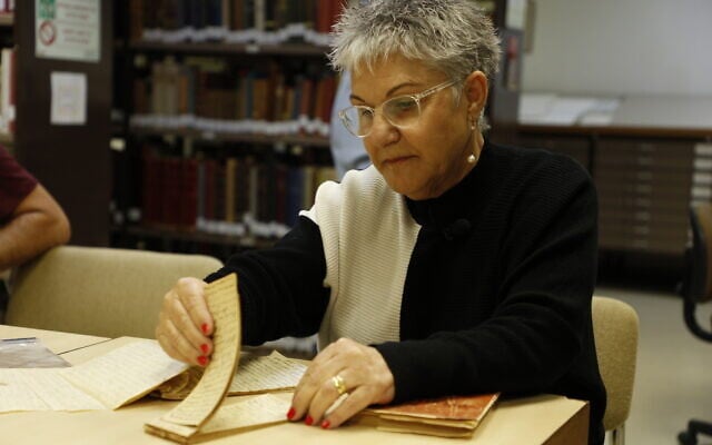 Lisa Castro with Francesco Cerrone diary, part of the National Library of Israel's Operation Diary: The Founding Generation for Israel's 75th (Courtesy Uri Bareket/National Library of Israel)