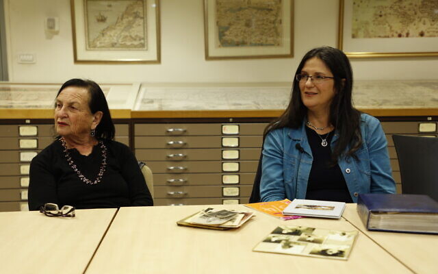 Zehava Galkop (left) and Michal Ashin, sister and daughter of Yehudit Entin with her diaries, part of the National Library of Israel's Operation Diary: The Founding Generation for Israel's 75th (Courtesy Uri Bareket/National Library of Israel)