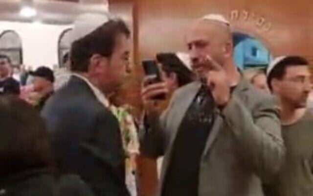 Likud MK Boaz Bismuth (left) is heckled during a Holocaust Memorial Day ceremony in Tel Aviv on April 17, 2023. (Screen capture/Twitter) Likud MK Boaz Bismuth (left) is heckled during a Holocaust Memorial Day ceremony in Tel Aviv on April 17, 2023. (Screen capture/Twitter)