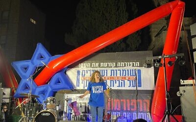 Activist Tovah Sheleg calls out chants for democracy at one of the anti-judicial overhaul protests in Jerusalem, organized by the grassroots organization Safeguarding Our Home from January through April 2023. (Courtesy Doron Gazit, protest artist, Safeguarding Our Home)