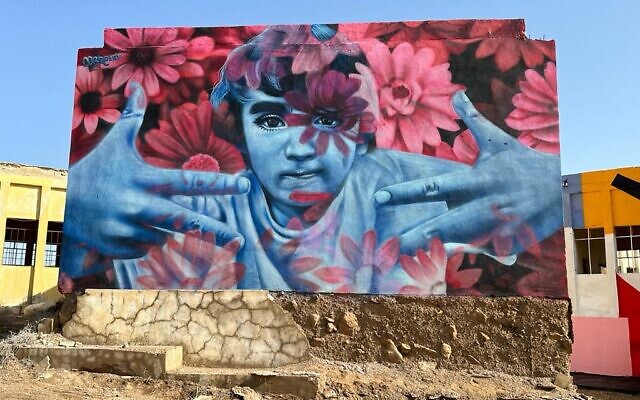 Artist Cobre painted a mural on abandoned Jordanian army barracks on the banks of the Dead Sea as part of Artists 4 Israel for Earth Day, April 22, 2023 (Courtesy Artists 4 Israel)