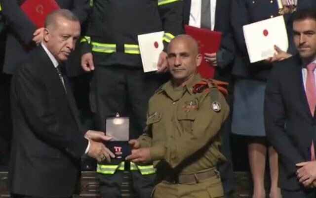 Turkish President Recep Tayyip Erdogan (L) awards Col. (res.) Golan Vach, who led the IDF Home Front Command search and rescue teams in Turkey following February's major earthquake, with a certification of appreciation on April 25, 2023. (Courtesy) Turkish President Recep Tayyip Erdogan (L) awards Col. (res.) Golan Vach, who led the IDF Home Front Command search and rescue teams in Turkey following February's major earthquake, with a certification of appreciation on April 25, 2023. (Courtesy)