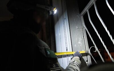 File: An Israeli soldier takes measurements at the home of a Palestinian gunman who killed an Israeli soldier, in the West Bank city of Nablus, early February 20, 2023. (Israel Defense Forces)