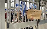 Protesters against the government's judicial overhaul greet participants of the Jewish Federations of North America’s General Assembly in Tel Aviv, April 23, 2023. (Carrie Keller-Lynn/Times of Israel)
