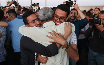 Relatives welcome Palestinian evacuees from Sudan upon their arrival at the Gaza Strip through the Rafah border crossing with Egypt, April 28, 2023. (Said Khatib/AFP)