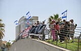 Protesters demonstrate against Israel's judicial overhaul, in front of the Jewish Agency for Israel's Board of Governors meeting in Tel Aviv, Israel on April 23, 2023. (Canaan Lidor/Times of Israel)