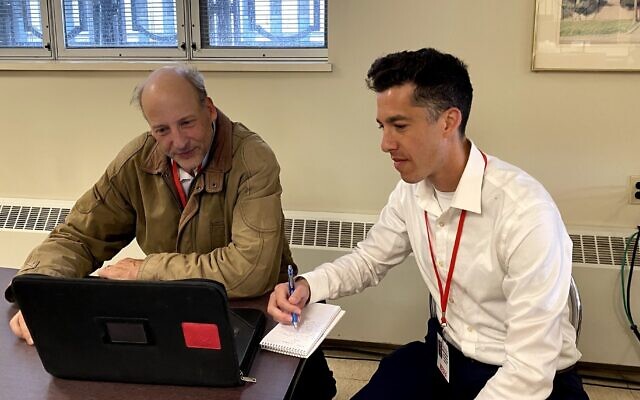 Torsten Ove, left, of the Pittsburgh Union Progress and Adam Reinherz of the PIttsburgh Jewish Chronicle confer on the first day of jury selection for the Pittsburgh synagogue massacre trial, April 24, 2023. (Toby Tabachnick via JTA)