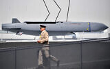 A member of the military walks past an MBDA Storm Shadow/Scalp missile at the Farnborough Airshow, southwest of London, on July 17, 2018. (Ben STANSALL / AFP)