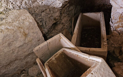 Inspectors for the Israel Antiquities Authority Theft Prevention Unit and the Kfar Kana police discovered these three ossuaries at a 1,800-year-old burial cave in northern Israel that was nearly destroyed by construction in May 2023. (courtesy Yoli Schwartz/IAA)