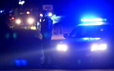 Police block a road near the village of Malo Orasje, just outside Mladenovac, about 60 kilometres (37 miles) south of Serbia's capital Belgrade, on May 5, 2023 where an attacker opened fire with an automatic weapon, state-run media reported. (Andrej Isakovic/AFP)