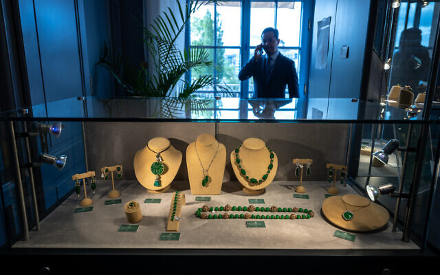 Christie's international head of jewelry, Rahul Kadakia, speaks on his mobile telephone behind a display case of jewels during a press preview of the 'World of Heidi Horten' sales in Geneva, on May 8, 2023. (Fabrice COFFRINI / AFP) Christie's international head of jewelry, Rahul Kadakia, speaks on his mobile telephone behind a display case of jewels during a press preview of the 'World of Heidi Horten' sales in Geneva, on May 8, 2023. (Fabrice COFFRINI / AFP)