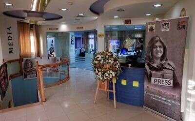 Pictures of slain Al Jazeera journalist Shireen Abu Akleh are displayed inside the news channel's office in Ramallah, May 9, 2023. (AHMAD GHARABLI / AFP)