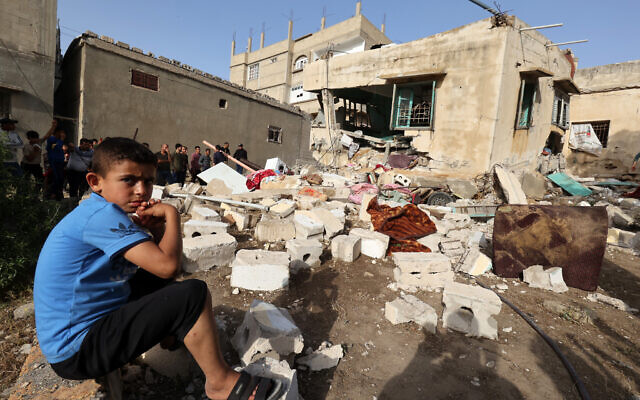 A boy sits amidst the rubble near of the house of Ahmed Abu-Deka on May 11, 2023, the deputy of the commander of a rocket launch unit killed by Israel on May 10. (Photo by SAID KHATIB / AFP) A boy sits amidst the rubble near of the house of Ahmed Abu-Deka on May 11, 2023, the deputy of the commander of a rocket launch unit killed by Israel on May 10. (Photo by SAID KHATIB / AFP)