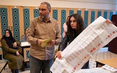 Election officials count ballots at a polling station after polls closed in Turkey's general elections in Istanbul on May 14, 2023. (Yasin AKGUL/AFP)