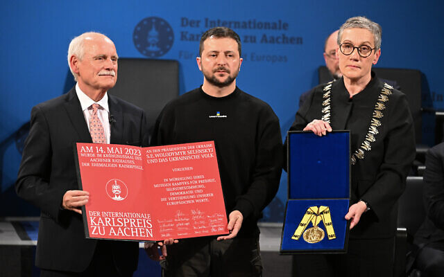 Ukraine's President Volodymyr Zelensky (center) is awarded the International Charlemagne Prize of Aachen 2023 by Juergen Linden (left), chairman of the Charlemagne Prize board of directors and Aachen's mayor Sibylle Keupen (right) on May 14, 2023 in Aachen, western Germany. (Federico Gambarini/ POOL/ AFP) Ukraine's President Volodymyr Zelensky (center) is awarded the International Charlemagne Prize of Aachen 2023 by Juergen Linden (left), chairman of the Charlemagne Prize board of directors and Aachen's mayor Sibylle Keupen (right) on May 14, 2023 in Aachen, western Germany. (Federico Gambarini/ POOL/ AFP)