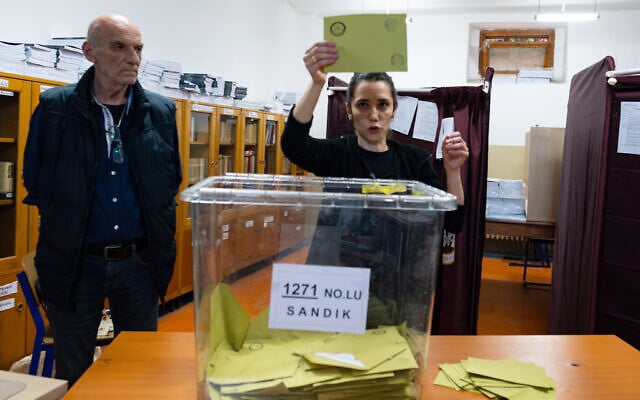 An electoral official shows a ballot during counting on the day of the second round of the presidential election in Istanbul on May 28, 2023. (Umit Turhan Coskun/AFP)