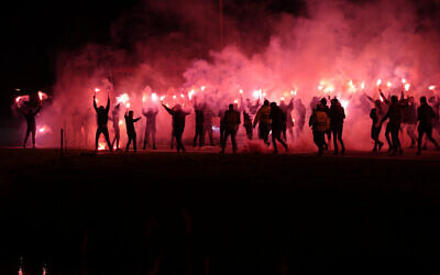 Illustrative: Supporters of Dutch soccer team AZ Alkmaar, some holding flares, run to meet the players' bus before the round of 16, second leg, Conference League soccer match between AZ and Lazio at the AZ stadium in Alkmaar, Netherlands, March 16, 2023. (AP Photo/Peter Dejong)