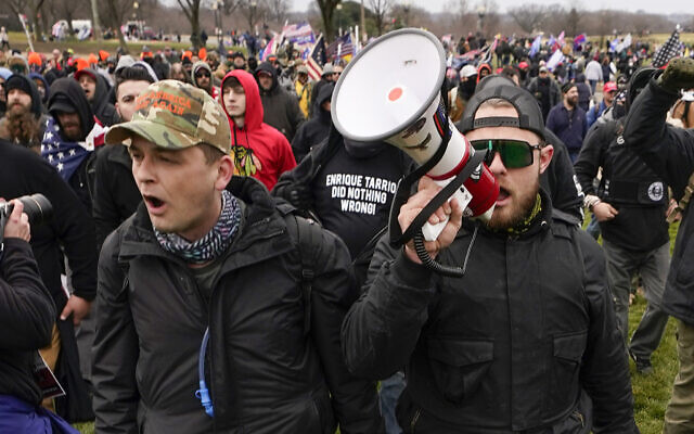 File: Proud Boys members Zachary Rehl, left, and Ethan Nordean, right, walk toward the US Capitol in Washington, in support of President Donald Trump on Jan. 6, 2021. Former Proud Boys leader Enrique Tarrio and three other members of the far-right extremist group were convicted Thursday, May 4, 2023, of a plot to attack the US Capitol in a desperate bid to keep Donald Trump in power after the Republican lost the 2020 presidential election. (AP/Carolyn Kaster) File: Proud Boys members Zachary Rehl, left, and Ethan Nordean, right, walk toward the US Capitol in Washington, in support of President Donald Trump on Jan. 6, 2021. Former Proud Boys leader Enrique Tarrio and three other members of the far-right extremist group were convicted Thursday, May 4, 2023, of a plot to attack the US Capitol in a desperate bid to keep Donald Trump in power after the Republican lost the 2020 presidential election. (AP/Carolyn Kaster)