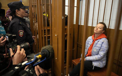Theater director Zhenya Berkovich sits in a cage in a courtroom prior to a hearing in a court in Moscow, Russia, Friday, May 5, 2023. (AP Photo/Alexander Zemlianichenko)