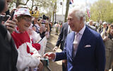 Britain's King Charles III greets wellwishers outside Buckingham Palace, in London, Friday, May 5, 2023, a day before his coronation takes place at Westminster Abbey. (James Manning/PA via AP)