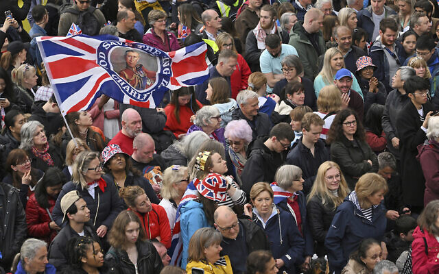 Well-wishers line the route of the King's Procession, a two-kilometer (1.2-mile) stretch from Buckingham Palace to Westminster Abbey in London, Saturday, May 6, 2023. (Sebastien Bozon/Pool Photo via AP)