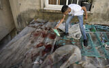 A boy looks at blood stains after an IDF  raid in the Nur Shams refugee camp near the city of Tulkarem, in the West Bank Saturday, May 6, 2023.  (AP Photo/Majdi Mohammed)