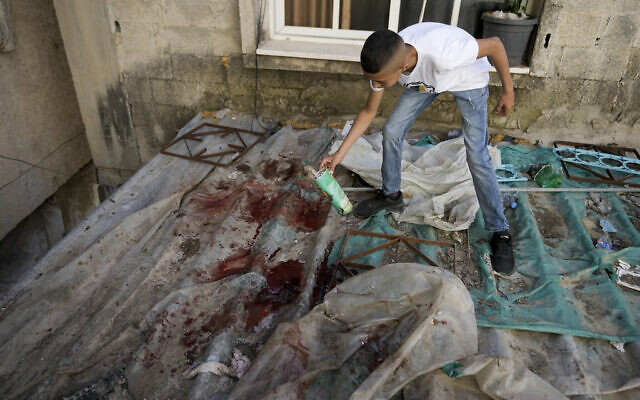 A boy looks at blood stains after an IDF raid in the Nur Shams refugee camp near the city of Tulkarem, in the West Bank Saturday, May 6, 2023. (AP Photo/Majdi Mohammed) A boy looks at blood stains after an IDF raid in the Nur Shams refugee camp near the city of Tulkarem, in the West Bank Saturday, May 6, 2023. (AP Photo/Majdi Mohammed)