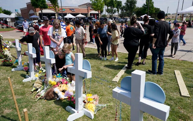 People look on at a makeshift memorial by the mall where several people were killed in Saturday's mass shooting, Monday, May 8, 2023, in Allen, Texas. (AP Photo/Tony Gutierrez) People look on at a makeshift memorial by the mall where several people were killed in Saturday's mass shooting, Monday, May 8, 2023, in Allen, Texas. (AP Photo/Tony Gutierrez)