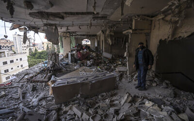 A Palestinian man inspects damage to his building following Israeli airstrikes on an apartment of an Islamic Jihad commander in Gaza City, May 9, 2023. (AP Photo/Fatima Shbair)