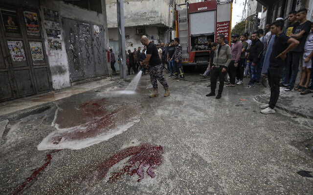 Palestinian firefighters clean blood stains at the site where two Palestinian gunmen where killed during an Israeli army raid in the Balata refugee camp in the West Bank city of Nablus, May 13, 2023. (AP Photo/Majdi Mohammed) Palestinian firefighters clean blood stains at the site where two Palestinian gunmen where killed during an Israeli army raid in the Balata refugee camp in the West Bank city of Nablus, May 13, 2023. (AP Photo/Majdi Mohammed)