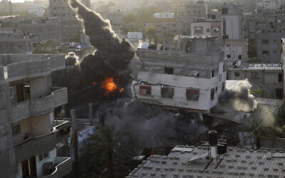 Smoke and fire rise from an explosion caused by an Israeli airstrike targeting a building in Gaza, May 13, 2023. The building was owned by an Islamic Jihad official. (AP Photo/Ashraf Amra)