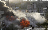 Smoke and fire rise from an explosion caused by an Israeli airstrike targeting a building in Gaza, May 13, 2023. The building was owned by an Islamic Jihad official. (AP/Ashraf Amra)