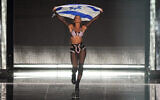 Noa Kirel of Israel during the flag ceremony during the Grand Finale of the Eurovision Song Contest in Liverpool, England, May 13, 2023. (AP Photo/Martin Meissner)