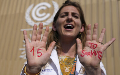 File: A demonstrator shows her hands reading '1.5 to survive' at a protest advocating for the warming goal at the COP27 UN Climate Summit, November 16, 2022, Sharm el-Sheikh, Egypt.  (AP/Peter Dejong)