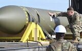 In this photo released by the US Air Force on May 2, 2023, airmen look at a GBU-57, or the Massive Ordnance Penetrator bomb, at Whiteman Air Base in Missouri (US Air Force via AP)