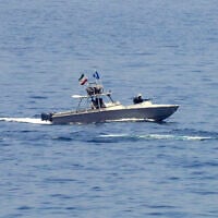 An Iranian Revolutionary Guard vessel watches an American warship in the Strait of Hormuz, May 19, 2023. (AP Photo/Jon Gambrell)