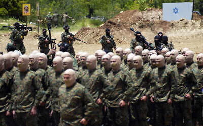 Fighters from the Lebanese terror group Hezbollah carry out a training exercise in Aaramta village in the Jezzine District, southern Lebanon, May 21, 2023. (AP Photo/Hassan Ammar)