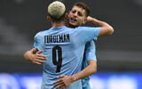 Israel's Ahmad Ibrahim celebrates with teammate Dor Turgeman after an own goal scored by Senegal's Babacar Ndiaye at a FIFA U-20 World Cup Group C soccer match at Diego Maradona stadium in La Plata, Argentina, Wednesday, May 24, 2023. (AP/Gustavo Garello)