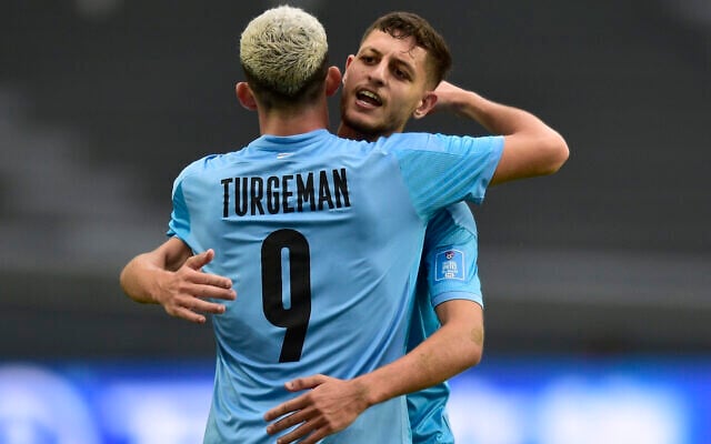 Israel's Ahmad Ibrahim celebrates with teammate Dor Turgeman after an own goal scored by Senegal's Babacar Ndiaye at a FIFA U-20 World Cup Group C soccer match at Diego Maradona stadium in La Plata, Argentina, Wednesday, May 24, 2023. (AP/Gustavo Garello) Israel's Ahmad Ibrahim celebrates with teammate Dor Turgeman after an own goal scored by Senegal's Babacar Ndiaye at a FIFA U-20 World Cup Group C soccer match at Diego Maradona stadium in La Plata, Argentina, Wednesday, May 24, 2023. (AP/Gustavo Garello)