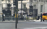British police at the scene after a car collided with the gates of Downing Street in London, May 25, 2023. (Ben Hatton/PA via AP)