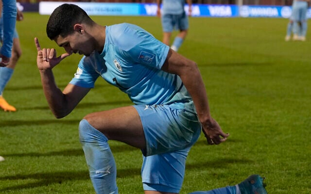 Israel's Anan Khalaili celebrates with Noa Kirel's unicorn sign after scoring his team's first goal against Uzbekistan during a FIFA U-20 World Cup round of 16 soccer match at the Malvinas Argentinas stadium in Mendoza, Argentina, May 30, 2023. (AP Photo/Ricardo Mazalan) Israel's Anan Khalaili celebrates with Noa Kirel's unicorn sign after scoring his team's first goal against Uzbekistan during a FIFA U-20 World Cup round of 16 soccer match at the Malvinas Argentinas stadium in Mendoza, Argentina, May 30, 2023. (AP Photo/Ricardo Mazalan)