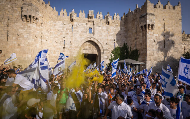 Thousands of Jews wave Israeli flags as they celebrate Jerusalem Day by dancing at Damascus Gate in Jerusalem's Old City, during Jerusalem Day, May 29, 2022. (Nati Shohat/Flash90) Thousands of Jews wave Israeli flags as they celebrate Jerusalem Day by dancing at Damascus Gate in Jerusalem's Old City, during Jerusalem Day, May 29, 2022. (Nati Shohat/Flash90)