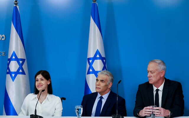 Then-prime minister Yair Lapid, center, then-Defense Minister Benny Gantz, right, and then-Energy Minister Karine Elharrar hold a press conference on the maritime border deal with Lebanon at the Prime Minister's office in Jerusalem, October 12, 2022. (Olivier Fitoussi/Flash90) Then-prime minister Yair Lapid, center, then-Defense Minister Benny Gantz, right, and then-Energy Minister Karine Elharrar hold a press conference on the maritime border deal with Lebanon at the Prime Minister's office in Jerusalem, October 12, 2022. (Olivier Fitoussi/Flash90)