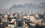 Trails of smoke are seen as rockets are fired from Gaza towards Israel, in Gaza City on May 2, 2023. (Atia Mohammed/Flash90)