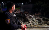 Police and army at the scene where a rocket fired from Gaza into southern Israel, hit and caused damage between houses in the southern city of Ashkelon, May 10, 2023. (Yonatan Sindel/Flash90)
